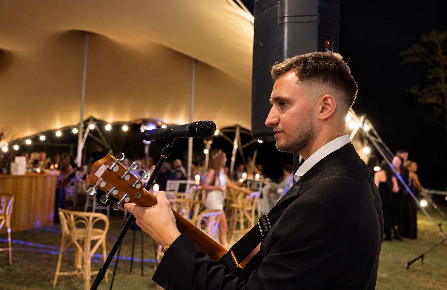 Agustin Kafka performing acoustic guitar and vocals at a wedding